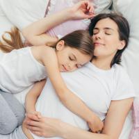 Family laying in bed