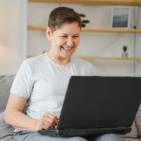 Woman Using Best Price Website on Laptop